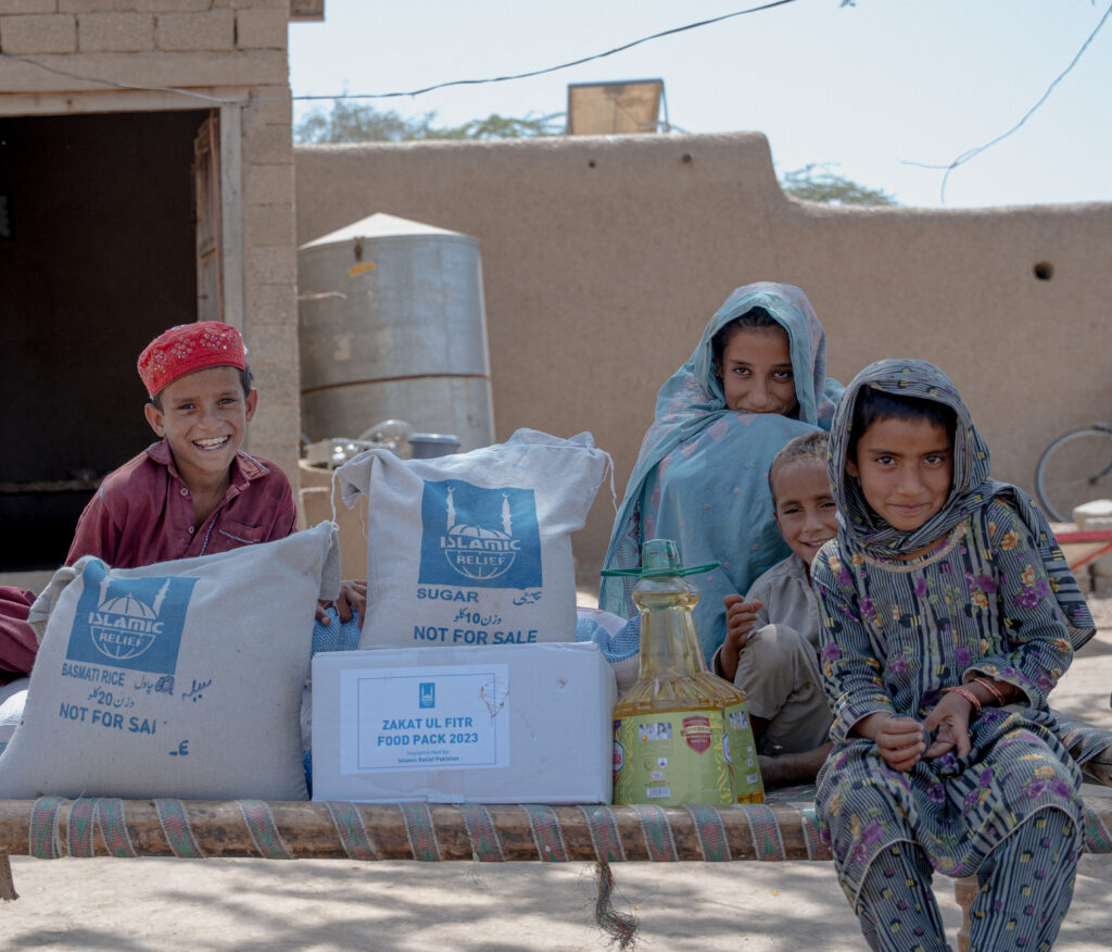 Children receiving Zakat al Fitr  food packs for Eid al Fitr 2023