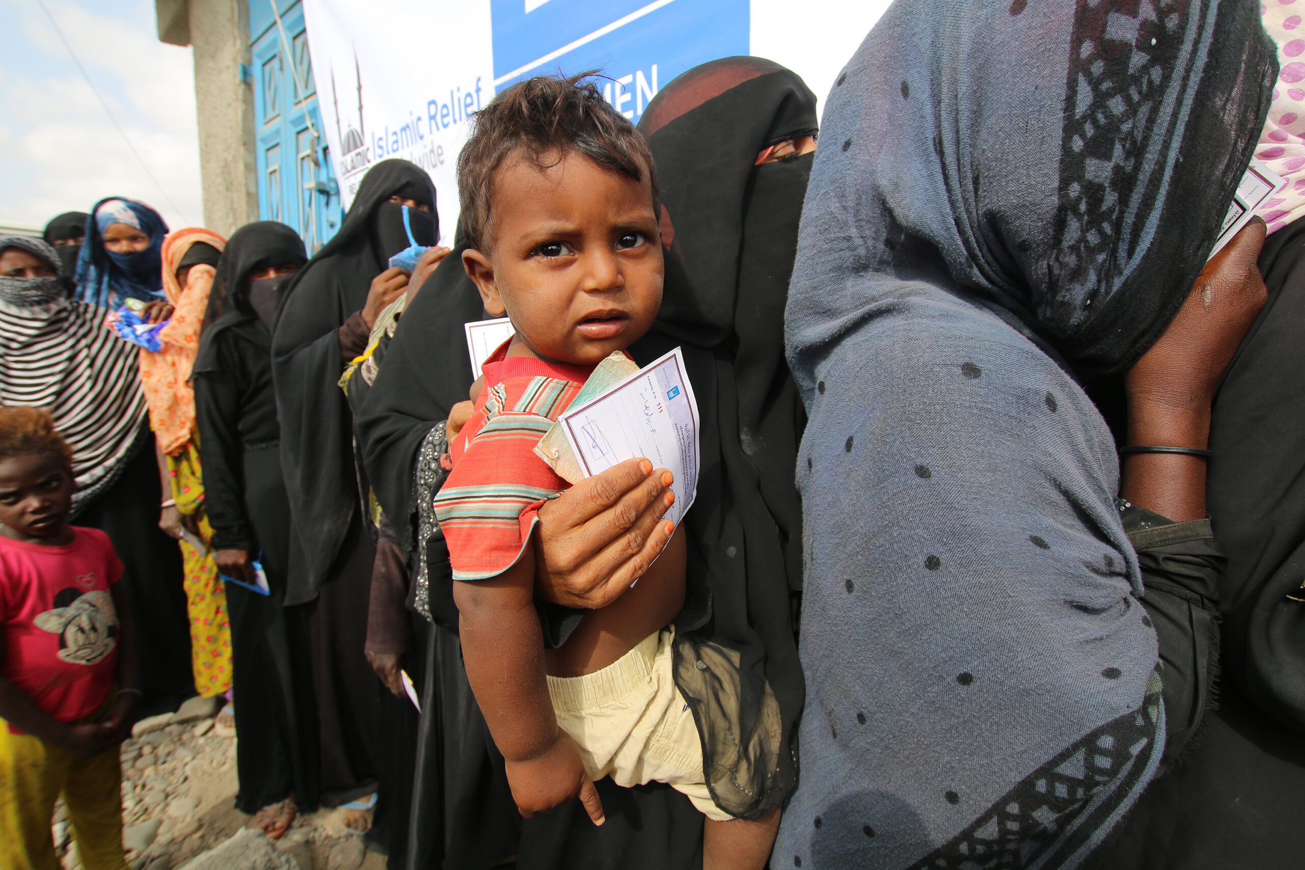 Women and Families Line Up for Voucher Collection in Yemen