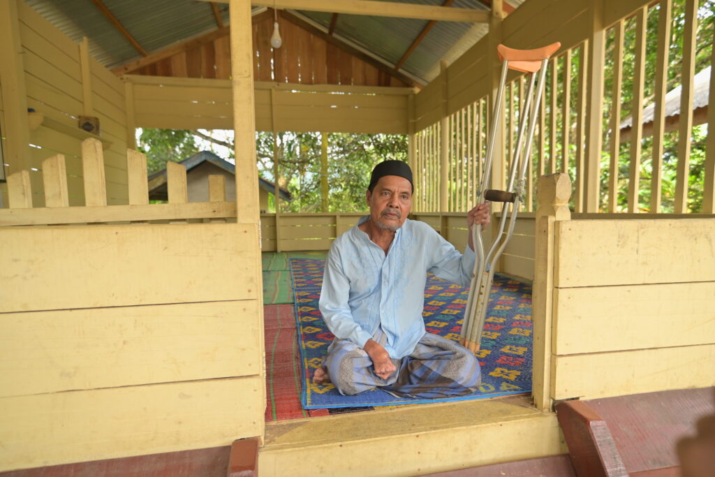 Ibrahim from Aceh, Indonesia, one of the recipients of the food pack, with his crutches. 