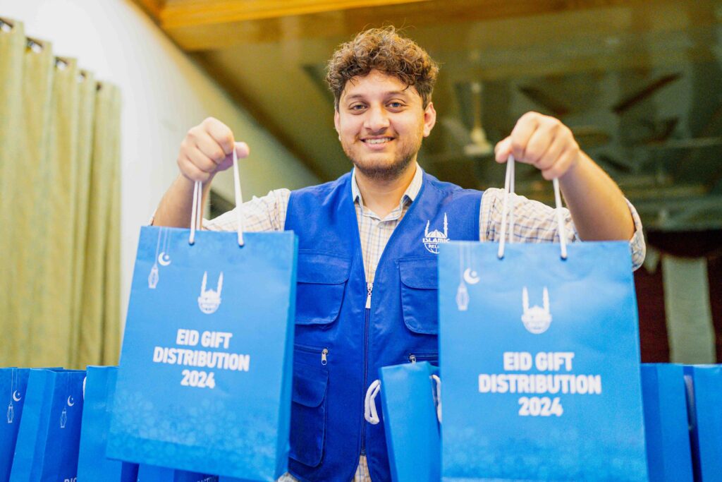 Islamic Relief Staff holding up Eid gifts for distribution.