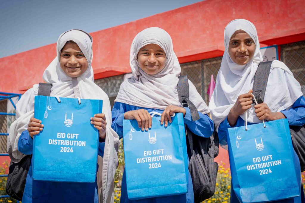 Young girls in Pakistan holding their eid gifts