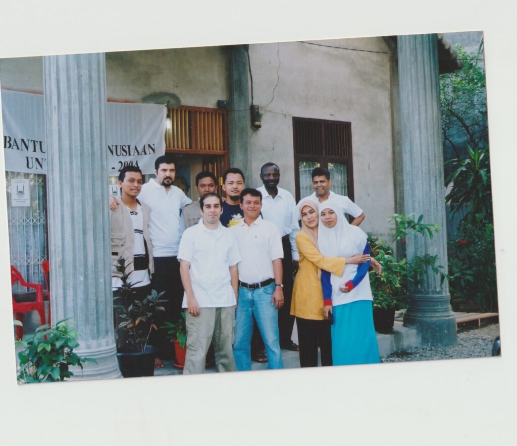 Haroon [front row, far left] poses with the team outside Islamic Relief’s makeshift office in Aceh. 

[Back row L-R: Febby, Yusuf, Rahmat, Rindro, Seifeldin, Abdul. Front row L-R: Haroon, Hasballah, Nurlina and Erdiana]