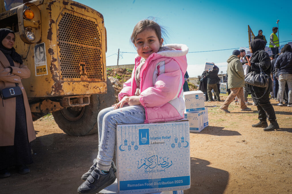 girl on a food pack, which you can give with Zakat through Islamic Relief and SNWMC