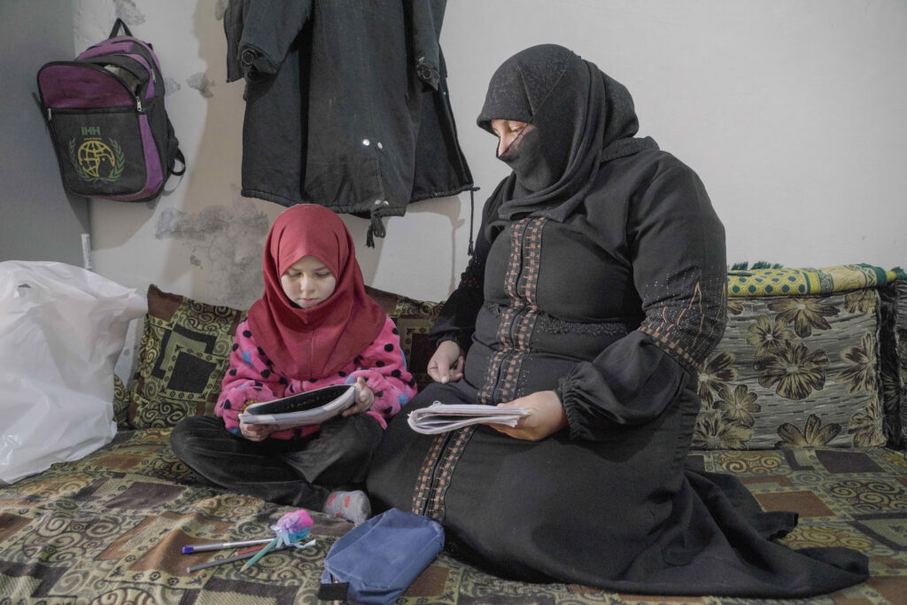 Umm Mahmoud and her youngest, Syrian Refugees, in their home