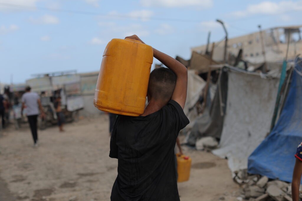 Sumud means a displaced Palestinian carrying water to their makeshift shelter