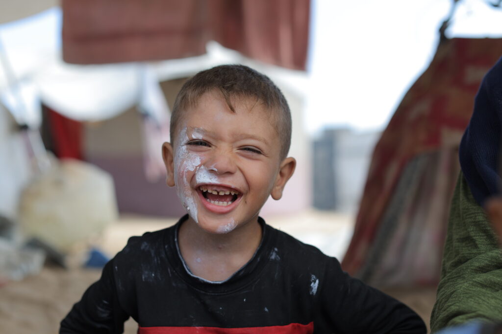 Sumud means a displaced Palestinian boy still smiling