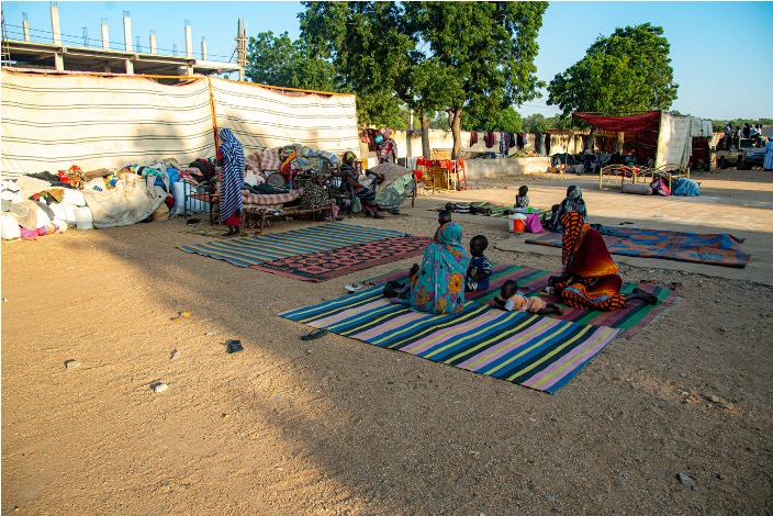 Displaced families in front of their makeshift shelters in Gedaref in Sudan