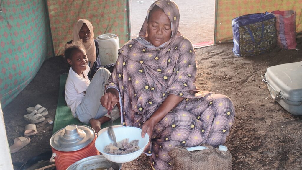 Halima, a mother of 4 in Sudan, cooking the qurban meat she received from Islamic Relief